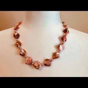 Stunning light coral color and pearl necklace.